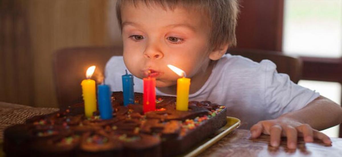 Blowing out birthday candles ups bacteria on cake by 1,400 pc