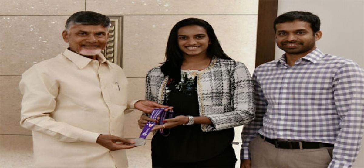 Chief Minister N Chandrababu Naidu  pats PV Sindhu, Pullela Gopichand