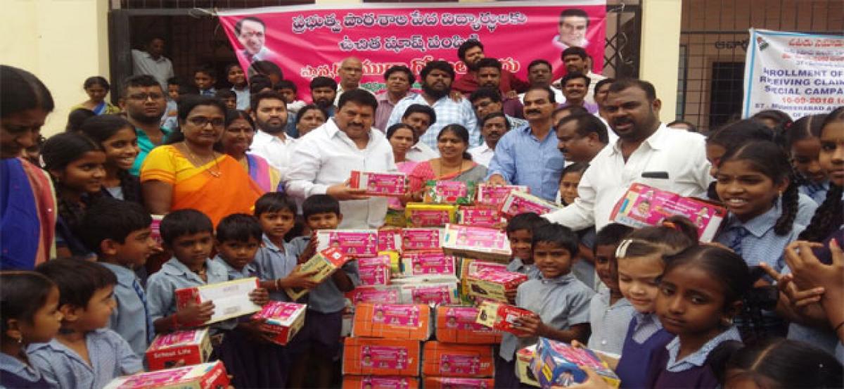 Muta Gopal distributes shoes to poor students