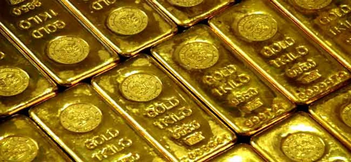 Gold prices steady as dollar holds gains