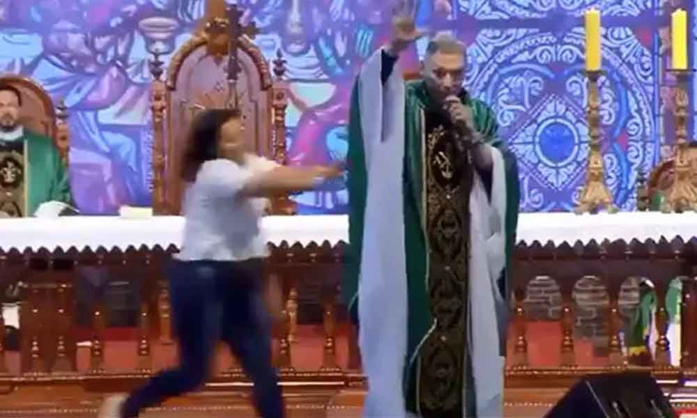Watch : Woman pushes priest off stage for fat shaming comments