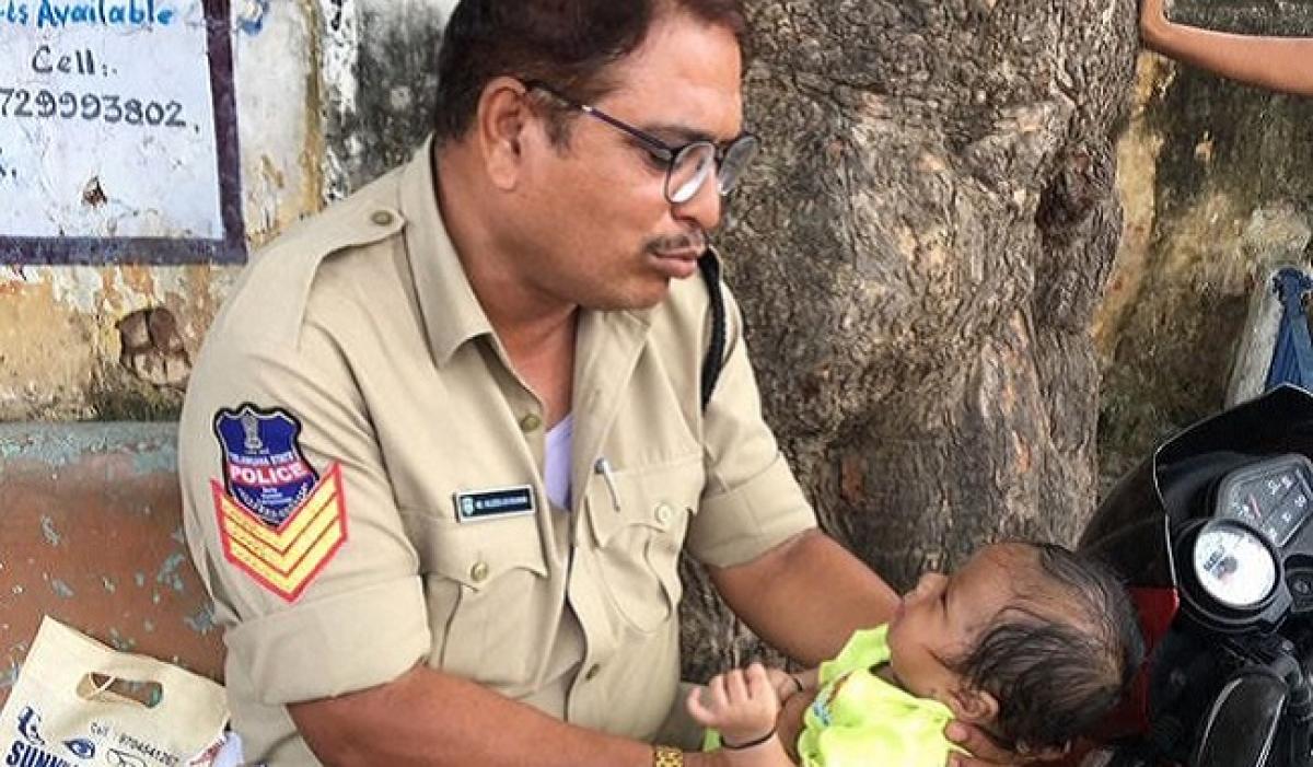 City police consoles baby as mother takes constable exam