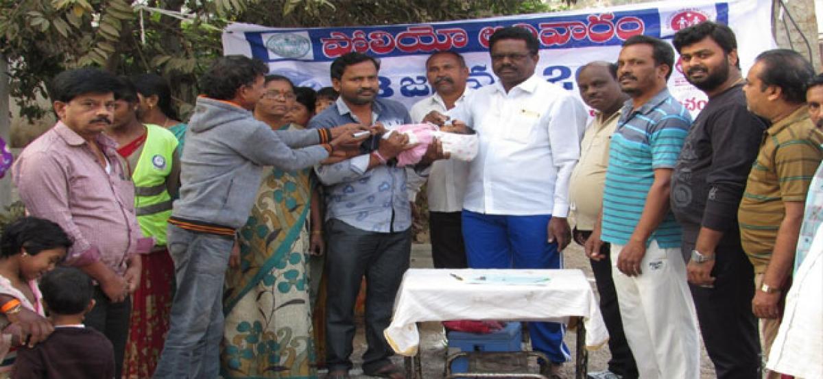 Corporator administers polio drops to children