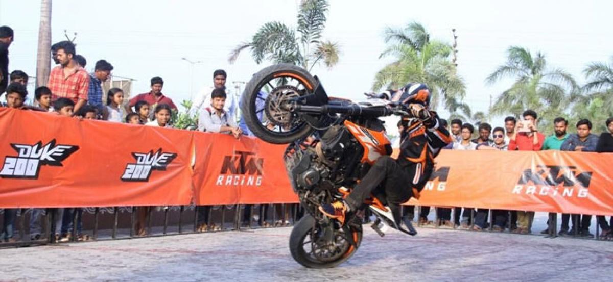 Professional stunt riders demonstrate tricks