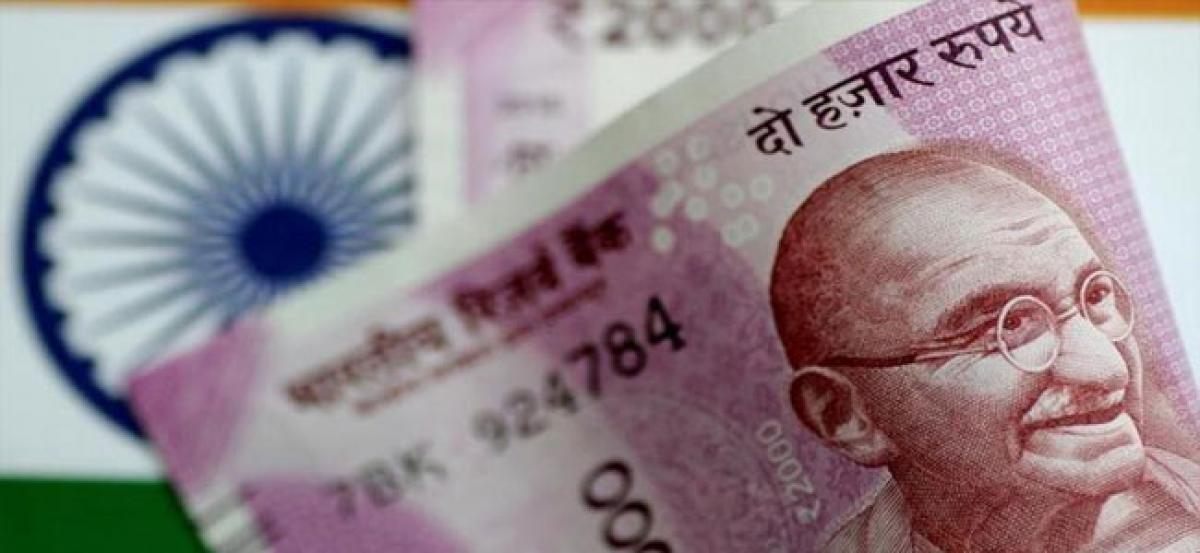 Rupee slumps 23 paise to 64.30 in late morning deals