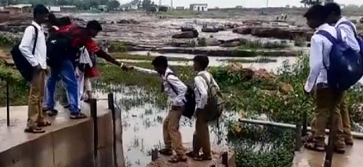 Madhya Pradesh: Bridge construction delayed, students cross rivulet to school