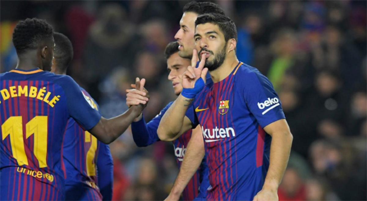 Suarez ‘tricks, swells Barca La Liga lead