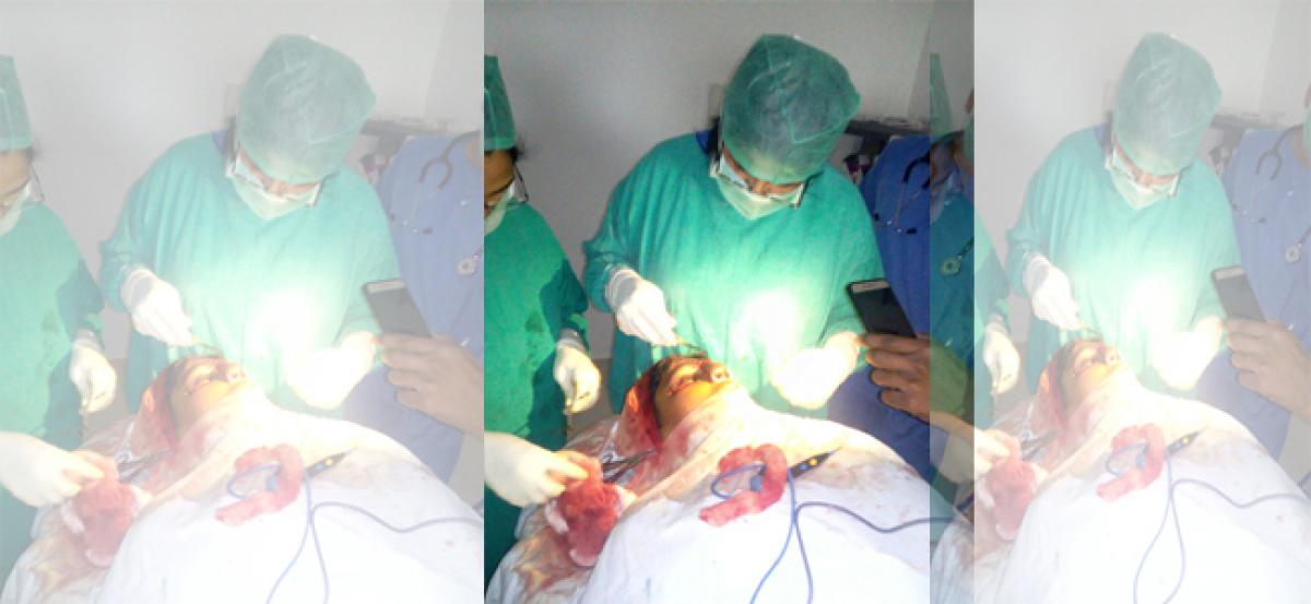 Doctors perform surgery under mobile torch