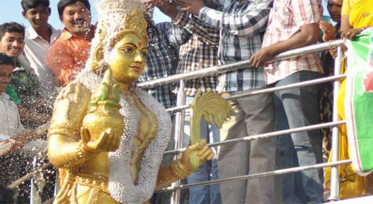 Milk bath given to Telugu Talli statue