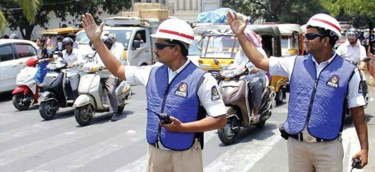 Traffic officials distribute buttermilk packets to traffic cops on duty