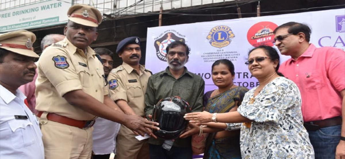Gandhi giri held for helmet less drivers at Nampally