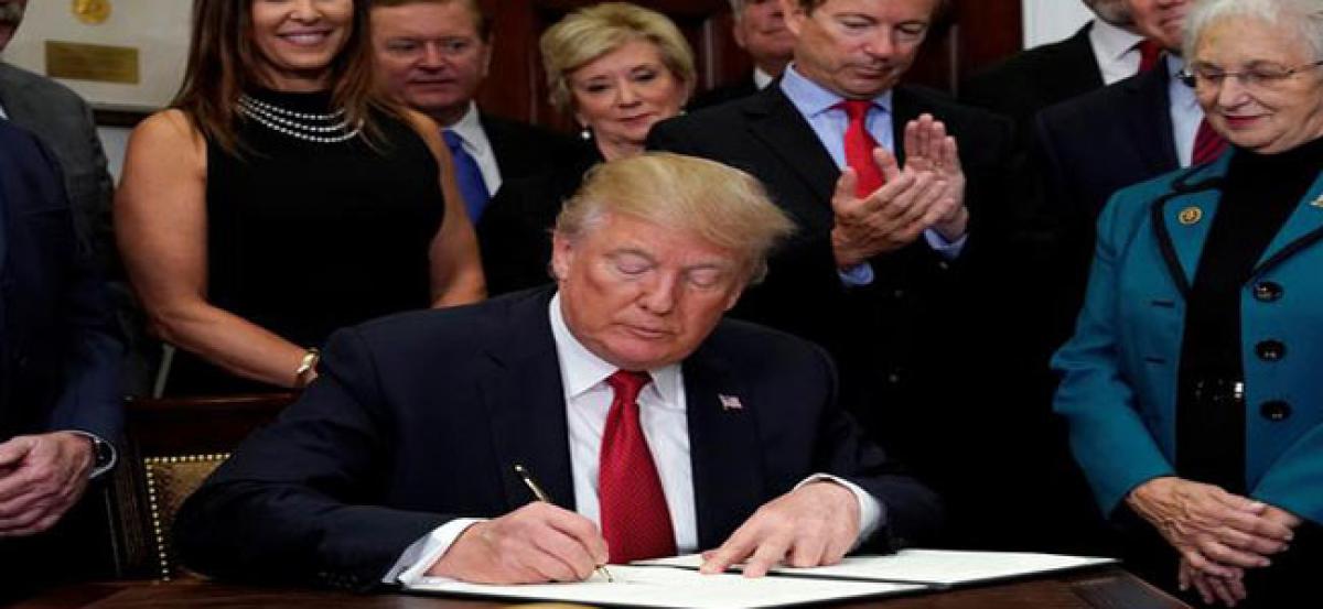 Trump signs executive order to ease Obamacare rules