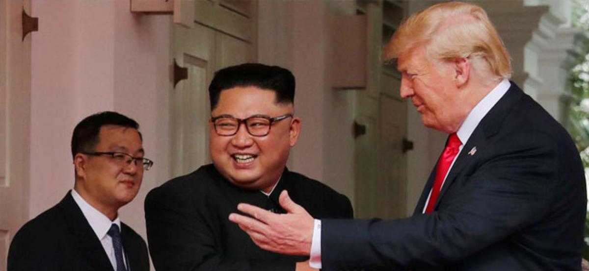 With handshakes, smiles and a thumbs up, Trump and Kim start historic Singapore summit