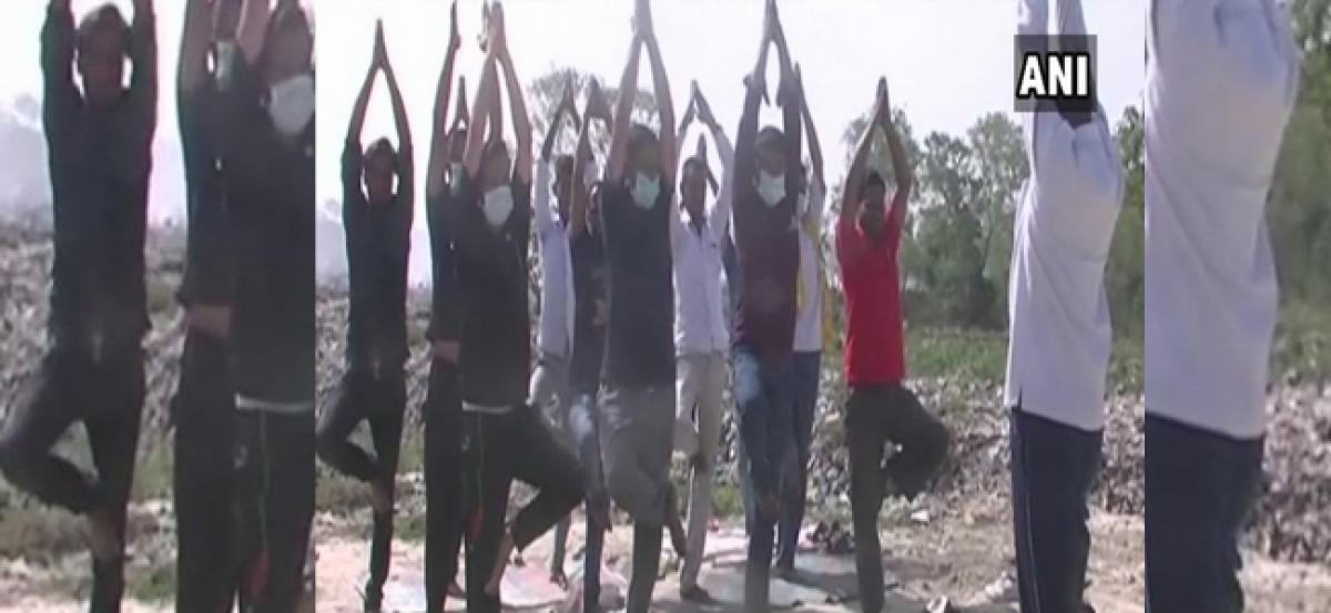 Locals in Ukhand perform yoga at trenching ground